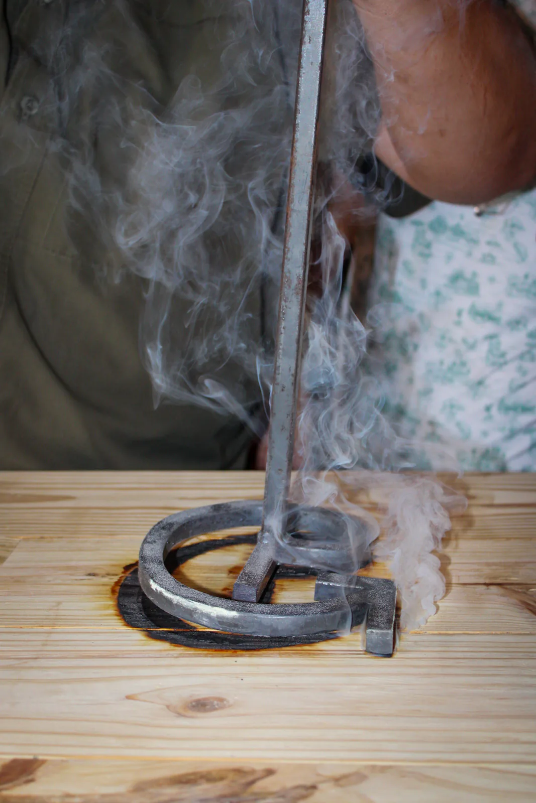 Close view of a glowing branding iron above the bar