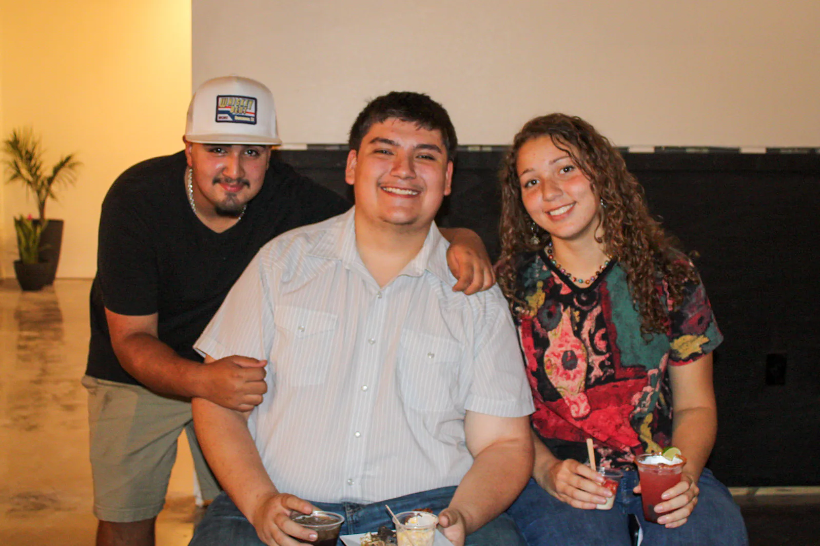 Friends smiling together with drinks at Brand the Bar