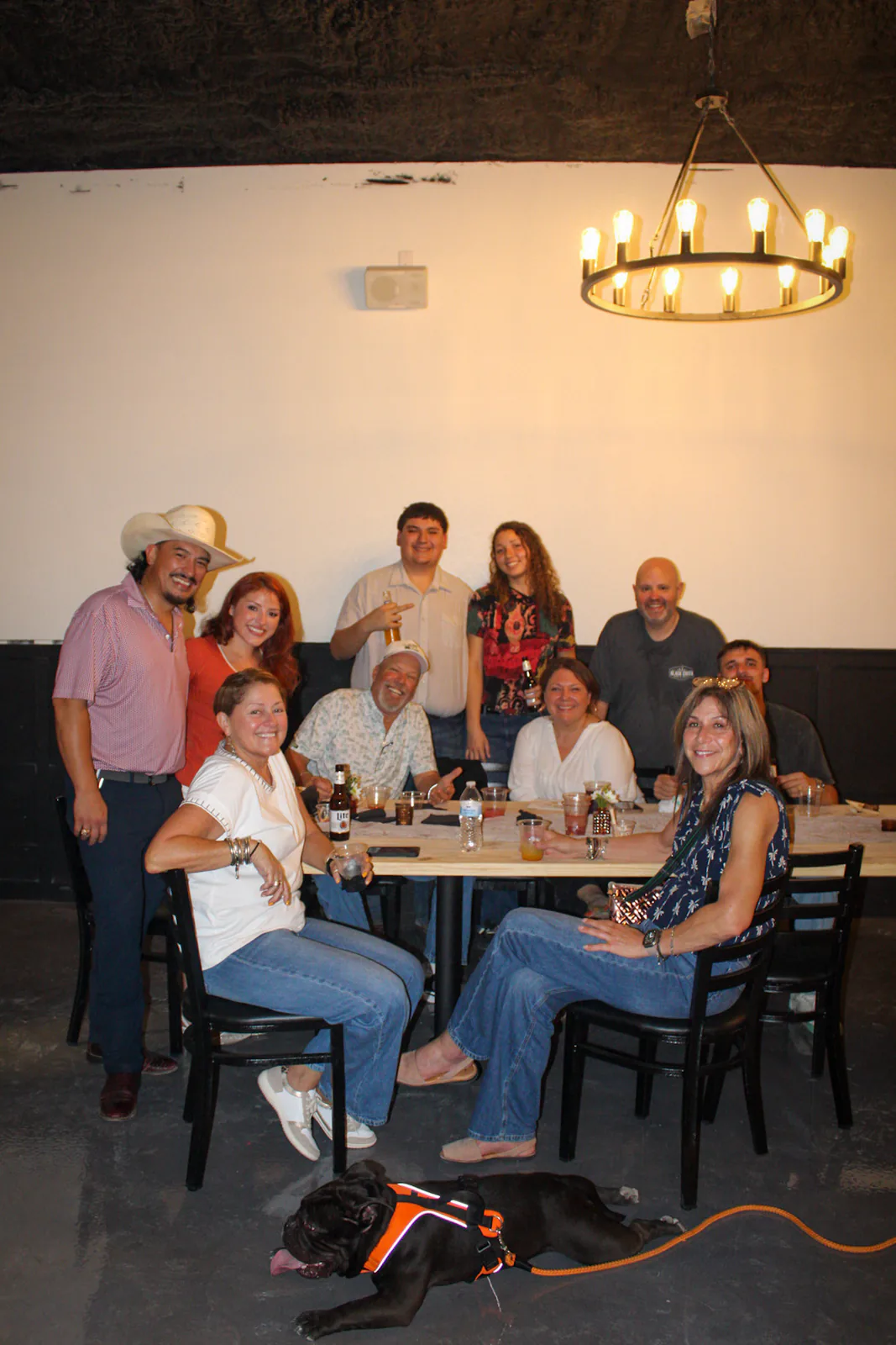 A group of guests smiling around a table
