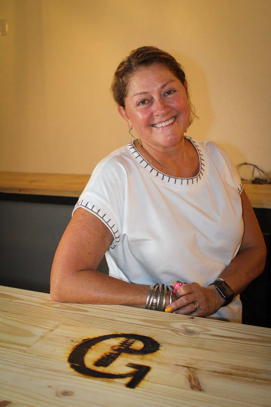 A guest smiling beside the newly branded bar