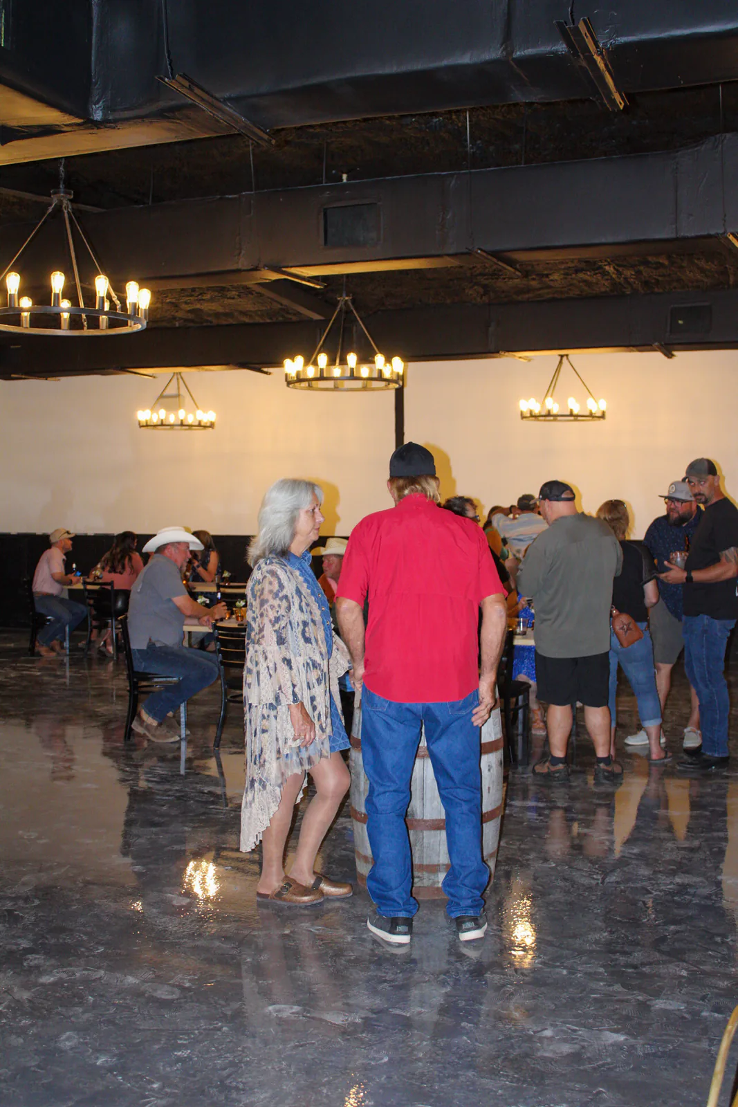 Open floor area, tables, and warm lighting inside The Warehouse