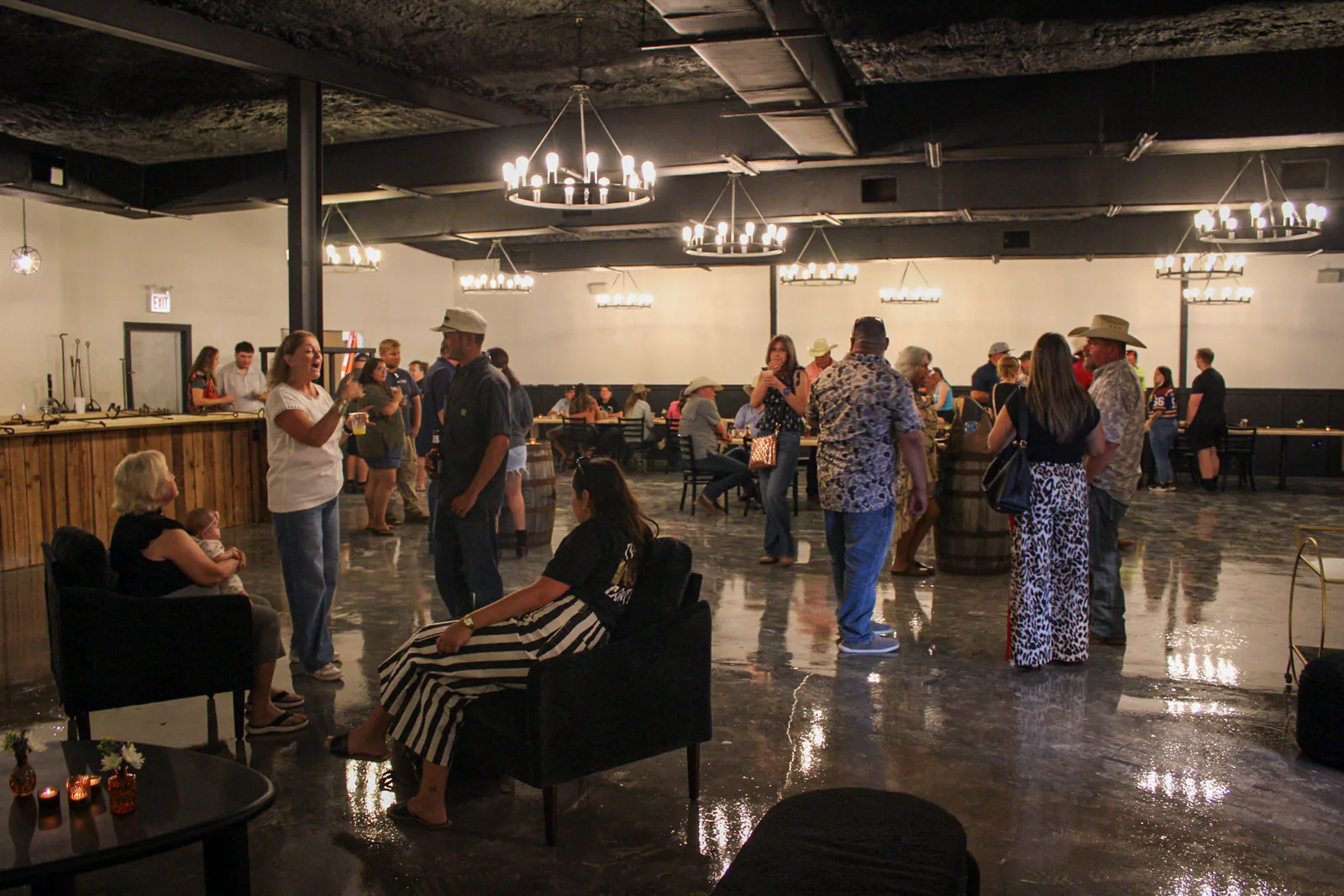 Wide view of guests seated and standing inside The Warehouse